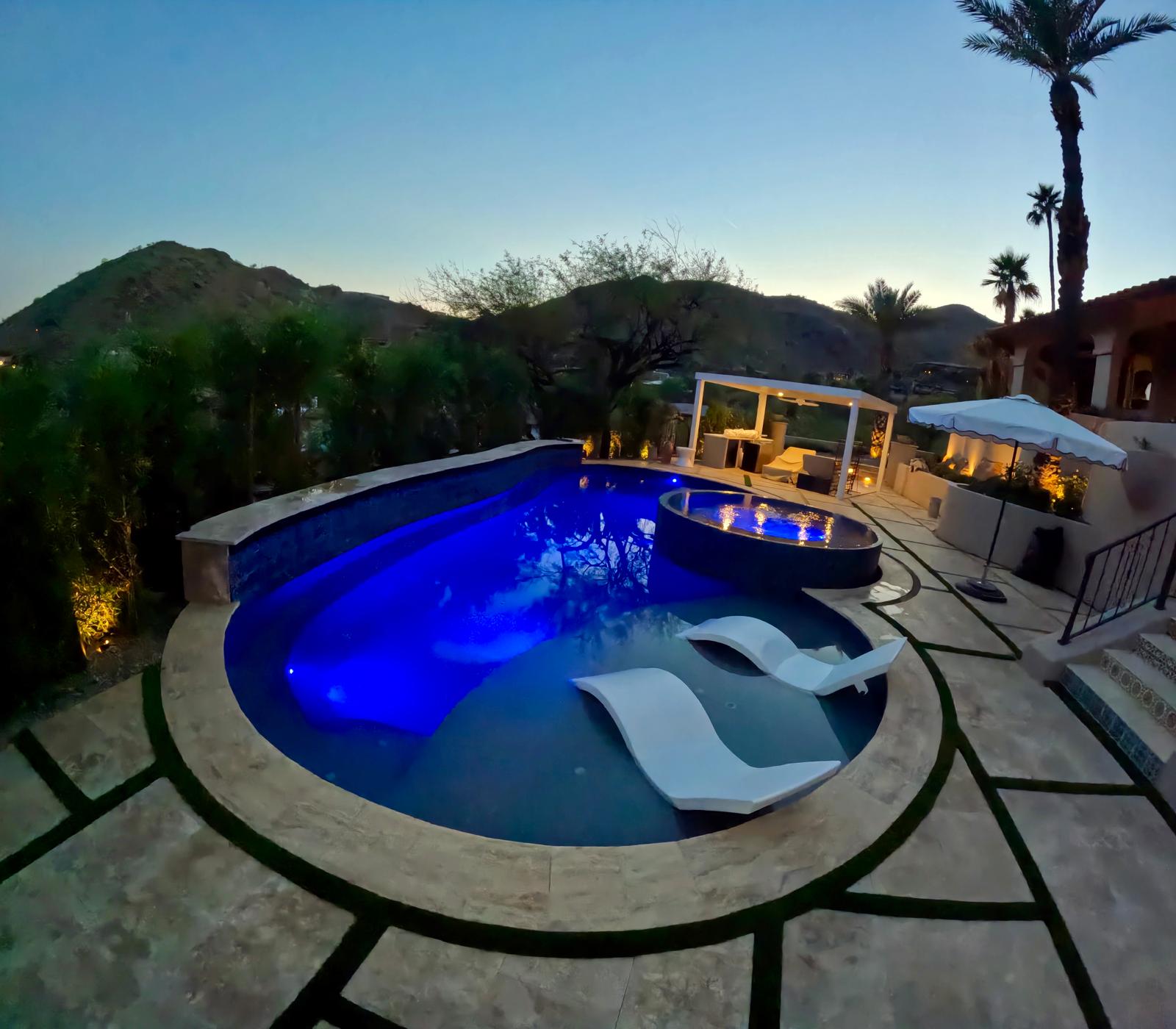 Residential swimming pool illuminated at night